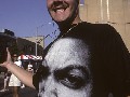 Audrey Gottlieb<br/>Smiling Man stands up in black & white t-shirt, 1994<br/>"Independence Day celebration on the waterfront, Long Island City, NY."