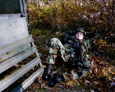 Soldier resting in leaves.