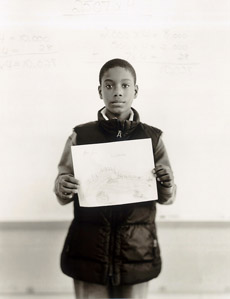 Portrait of boy holding drawing.