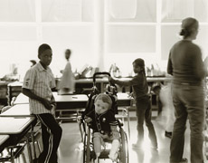 Children in a classroom. One child is in a wheelchair.