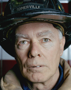 Close-up portrait of a man wearing fire helmet.