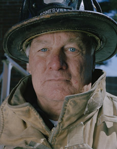 Portrait of a man wearing fire gear.